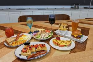 a table with plates of food and glasses of wine at Four Points by Sheraton Birmingham Homewood in Homewood