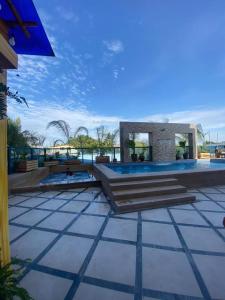 a pool with stairs and a building in the background at Playa el Mansito Apartamento Ocean Sun in Punta Blanca