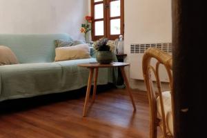 a living room with a couch and a table at Maisonnette au pied du Mont Ventoux ste colombe in Bédoin