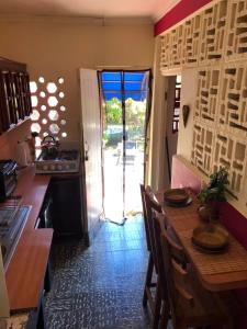 a kitchen with a table and a door to a yard at BnB SoMom Mobay Lodging in Montego Bay
