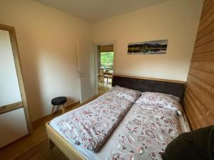 een slaapkamer met een groot bed met een houten hoofdeinde bij Camping Hierhold in Kumberg
