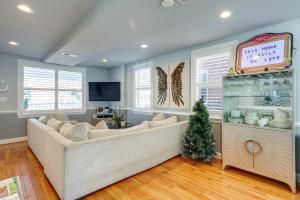 a living room with a couch and a christmas tree at Hot Tub and Rooftop Game Room Unique Home in DC in Washington