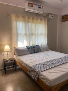 1 dormitorio con 1 cama grande y ventana en Kadam Villa, en Diveagar