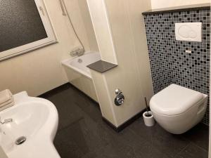 a bathroom with a white toilet and a sink at Ferienwohnung/Monteurwohnung/ Kurzzeitmiete in Bracht in Brüggen