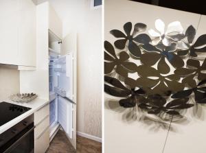 a kitchen with a painting of flowers on the wall at Celebration Flat by Ruterra in Prague