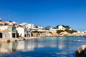 a view of a river with white buildings at La maison dans la calanque 1 mn à pied de la plage d'ALCAUFAR 