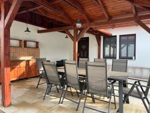 a dining room with a table and chairs at Filip Vendégház in Galvács