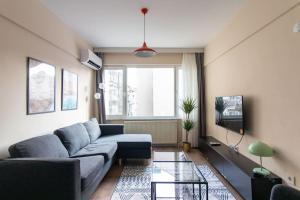 a living room with a couch and a tv at Modern & Newly furnished 1BR Flat w/ Balcony & AC in Istanbul