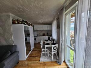 a kitchen and dining room with a table and chairs at Апартамент за гости Боляри in Velingrad