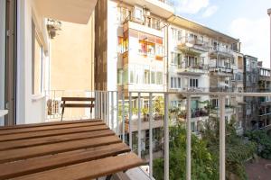 a balcony with a wooden bench on a building at Modern & Newly furnished 1BR Flat w/ Balcony & AC in Istanbul
