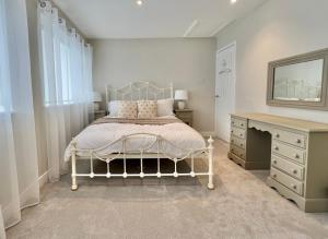a bedroom with a bed and a desk and a mirror at Incredible Views in Dartmouth with Parking and EV Charger in Dartmouth