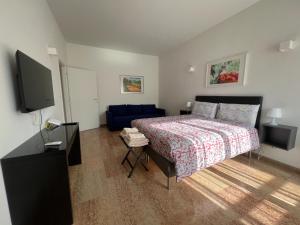 a bedroom with a bed and a flat screen tv at Appartamento Barbieri in Bologna