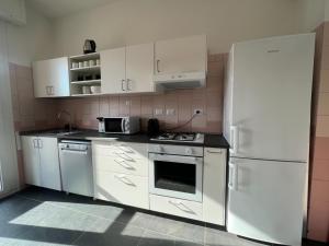 a kitchen with white appliances and a white refrigerator at Appartamento Barbieri in Bologna