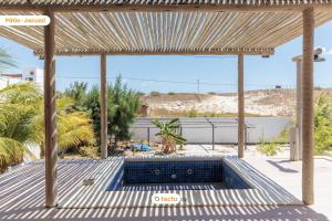 a view from the patio of a house with a swimming pool at Casa a 150m da praia no Pontal do Maceió por Tactu in Maceio