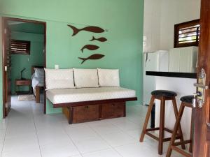 a bedroom with a bed with fins on the wall at DECK HOUSE in Tatajuba +4 photos