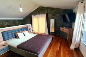 ein Schlafzimmer mit einem großen Bett und einem Fenster in der Unterkunft Haven of Serenity in São Vicente