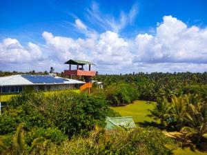 an aerial view of a house with solar panels on the roof at Yala Bay Holiday Resort in Tissamaharama