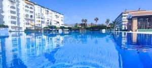 a large pool of water in front of some buildings at Laguna Green Apartment in Torrox Costa