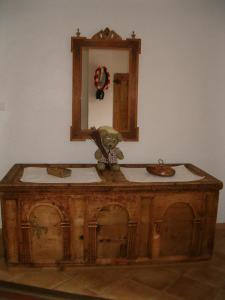 a wooden vanity with two sinks and a mirror at Valtnerhof in San Candido