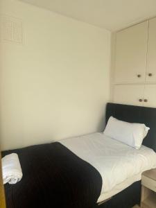a bedroom with a bed with a black and white blanket at 3-Bedroom house with private driveway in Adel