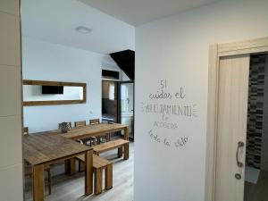 a dining room with a wooden table and a dining room at Alameda Amable in La Zarza de Pumareda