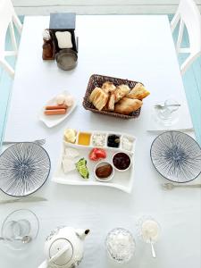 a white table with a tray of food on it at Sea View in Astara