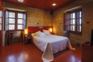 Ένα ή περισσότερα κρεβάτια σε δωμάτιο στο Casa Rural Torre Lombarda