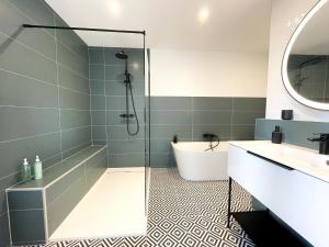 a bathroom with a shower and a tub and a sink at Le Petit Rousseau - Maison Climatisé - Classé 4 ETOILES in Hurigny +19 photos