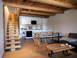 a kitchen and living room with a table and a dining room at La ferme d'Hauteluce - Chalets in Hauteluce