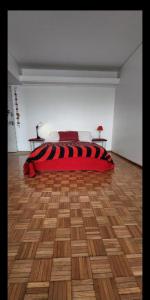 a bed in a room with a wooden floor at Casa Cúpulas de la Ciudad in Buenos Aires