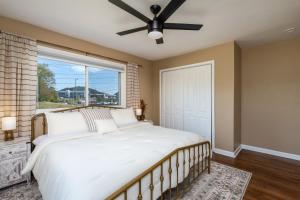 a bedroom with a large bed and a window at NEW Dragster Dream House 3BD2BA Game Room in Bluff City