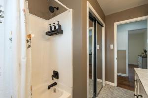 a bathroom with a bath tub and a shower stall at NEW Dragster Dream House 3BD2BA Game Room in Bluff City +24 photos