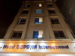 a building with a sign in front of it at Hotel Buddha International in Patna