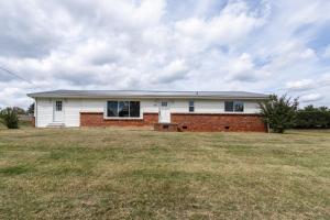 a white house with a brick at NEW Dragster Dream House 3BD2BA Game Room in Bluff City