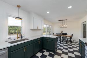 a kitchen with green cabinets and a checkered floor at NEW Dragster Dream House 3BD2BA Game Room in Bluff City