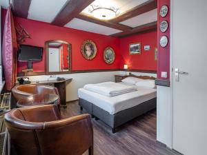 a hotel room with two beds and a tv at A-Train Hotel in Amsterdam +161 photos