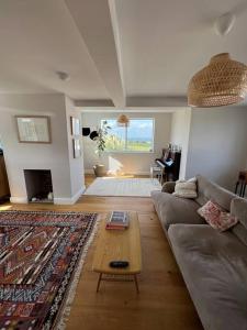 a living room with a couch and a coffee table at Stunning home with magnificent views in East Devon in Exeter