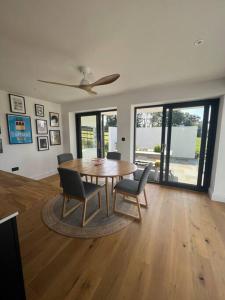 a dining room with a wooden table and chairs at Stunning home with magnificent views in East Devon in Exeter