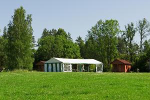 a tent in the middle of a field at Grāveri kempings in Usma