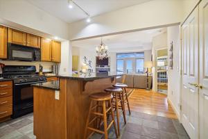 a kitchen with a island with bar stools at Gorgeous views, tastefully decorated Ski on ski off 3 bedroom condo, with sports center access Lodges 303 in Killington