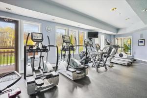 a gym with a bunch of exercise equipment in a room at Gorgeous views, tastefully decorated Ski on ski off 3 bedroom condo, with sports center access Lodges 303 in Killington