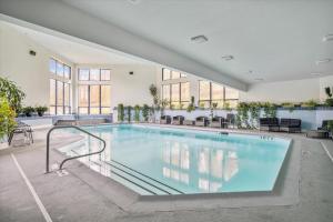 a large swimming pool in a building at Gorgeous views, tastefully decorated Ski on ski off 3 bedroom condo, with sports center access Lodges 303 in Killington