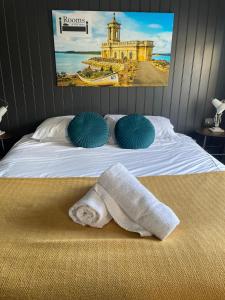 a bedroom with a bed with towels on it at The Angler, Oakham in Oakham