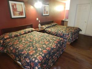 a hotel room with two beds in a room at Seagem Motel and Apartments in Seaside Heights