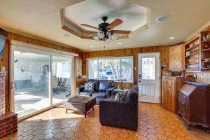 a living room with a ceiling fan and a couch at Downtown Carlsbad Apartment Less Than half Mi to Beach! in Carlsbad