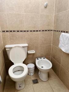 a bathroom with a toilet and a bidet at Departamento Nórdico San Juan in San Juan