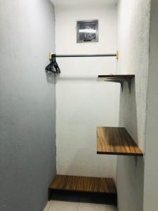 a room with two wooden shelves on a wall at Casa Tanah in Guadalajara