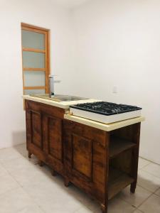 a kitchen counter with a sink and a stove at Casa Tanah in Guadalajara