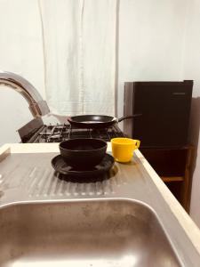 a stove top with two pans on top of it at Casa Tanah in Guadalajara
