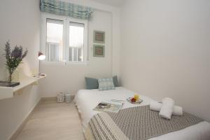 Cette chambre blanche dispose d'un lit et d'une fenêtre. dans l'établissement SingularStays Calderon, à Valence